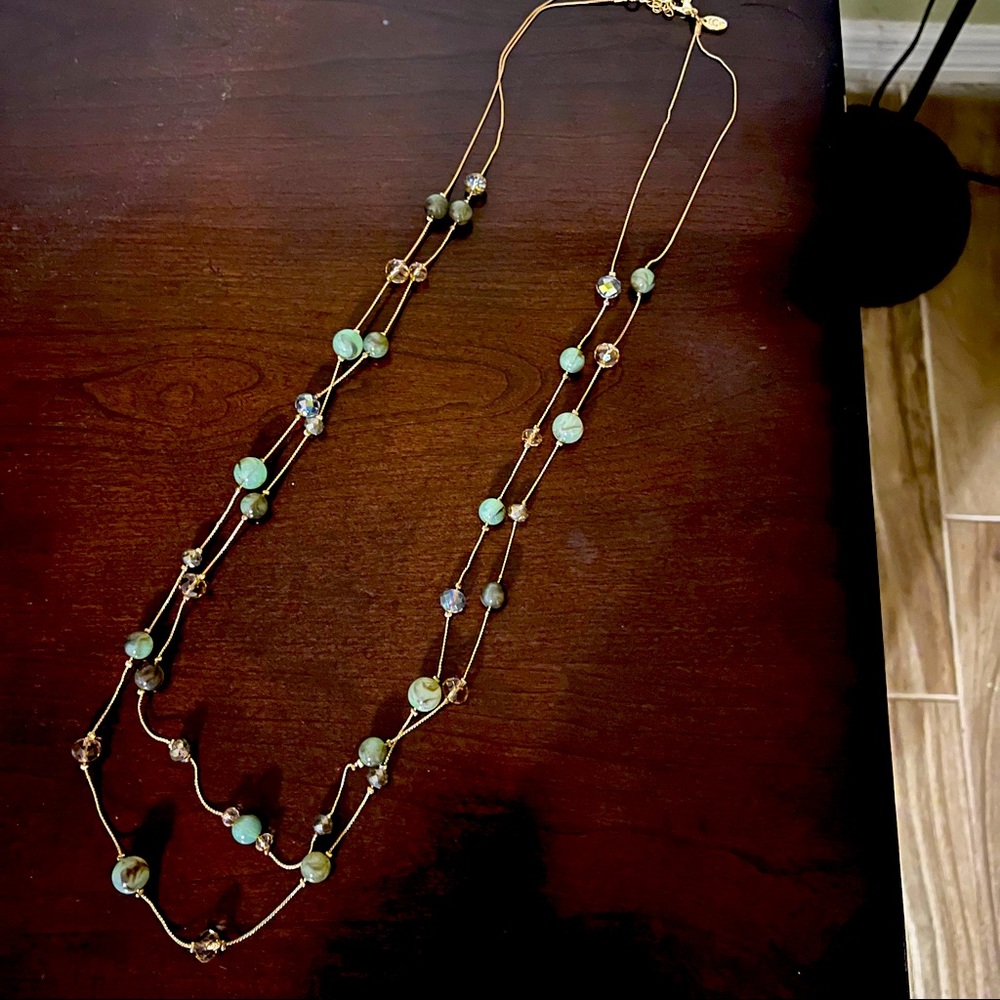 Long gold tone necklace with multi strand green glass beads
